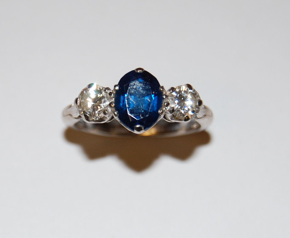 A three stone platinum set diamond and sapphire ring