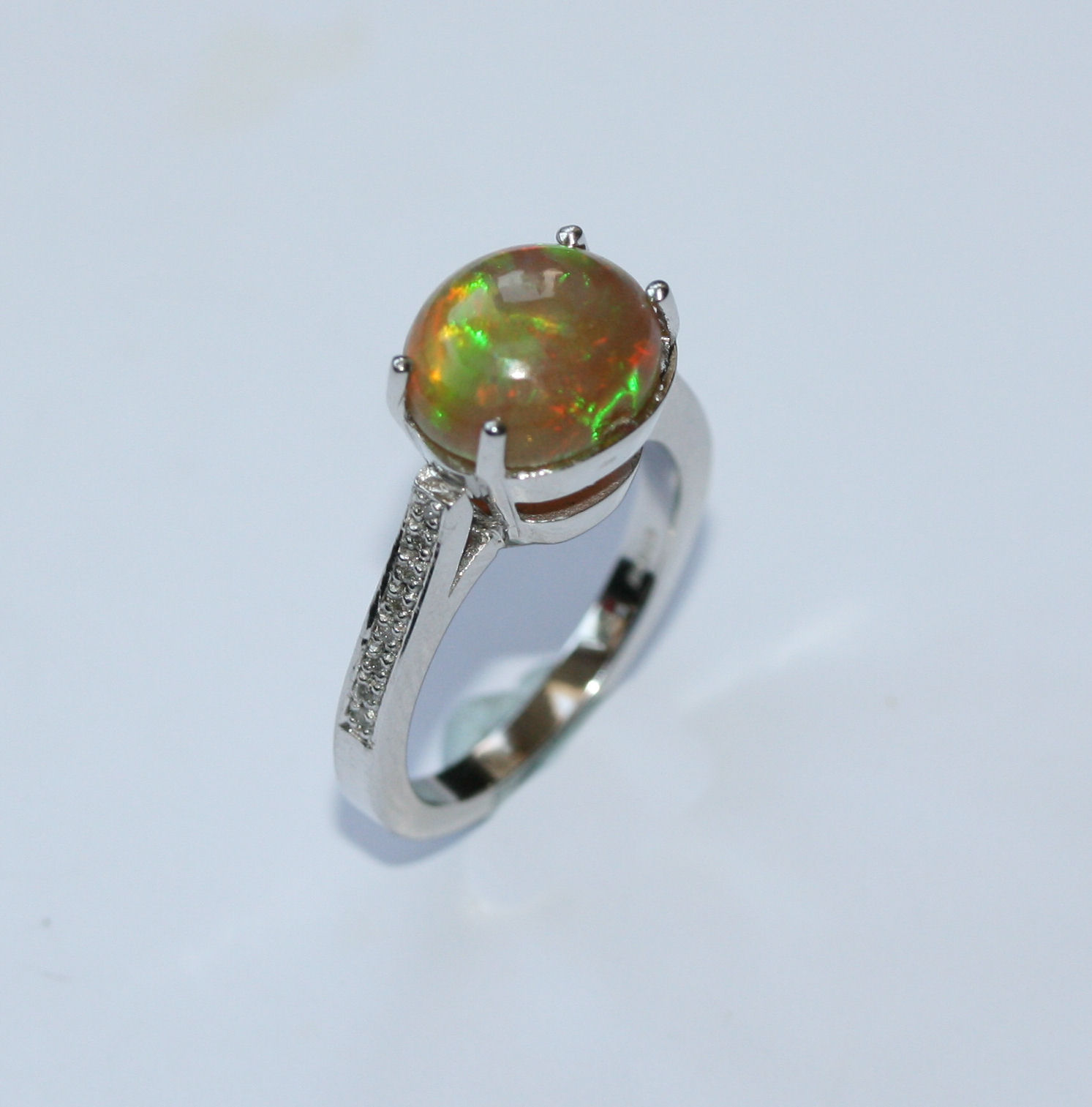 An 18ct white gold mounted opal and diamond set ring