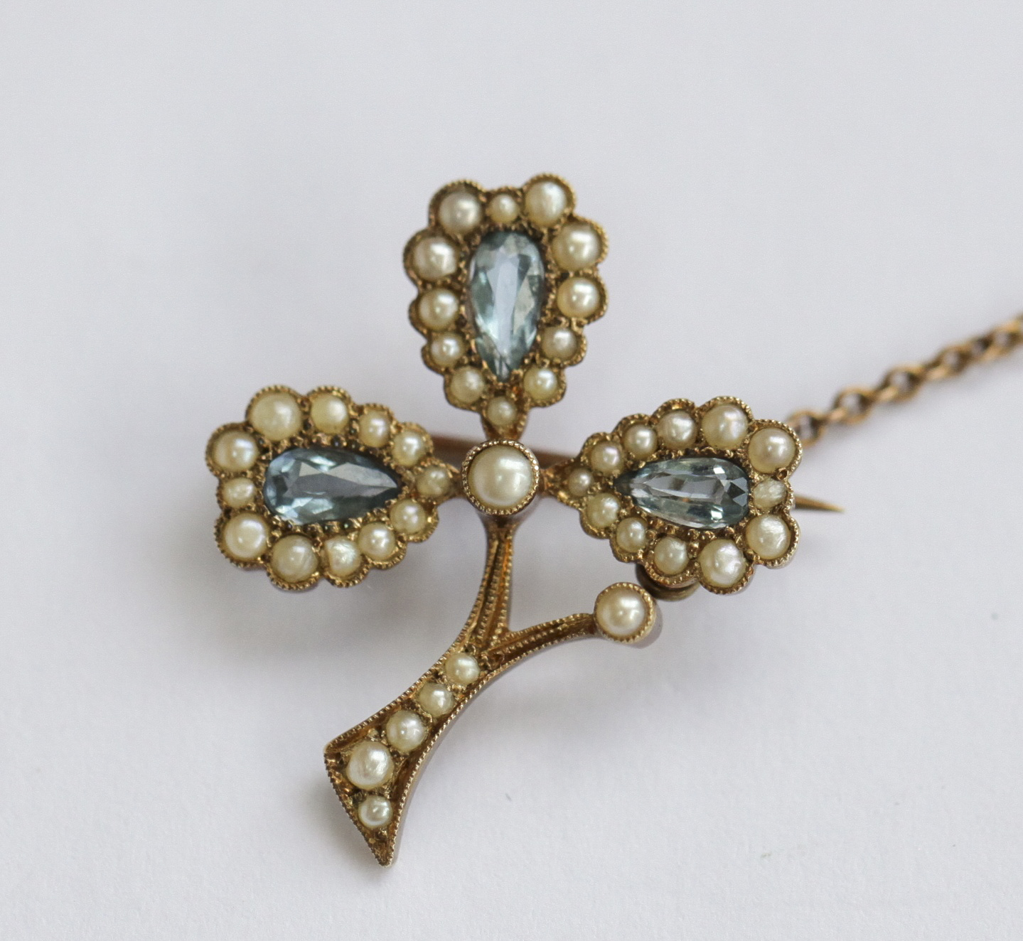 An aquamarine and pearl set brooch