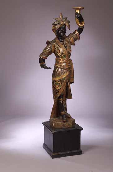 A painted and carved torchere figure