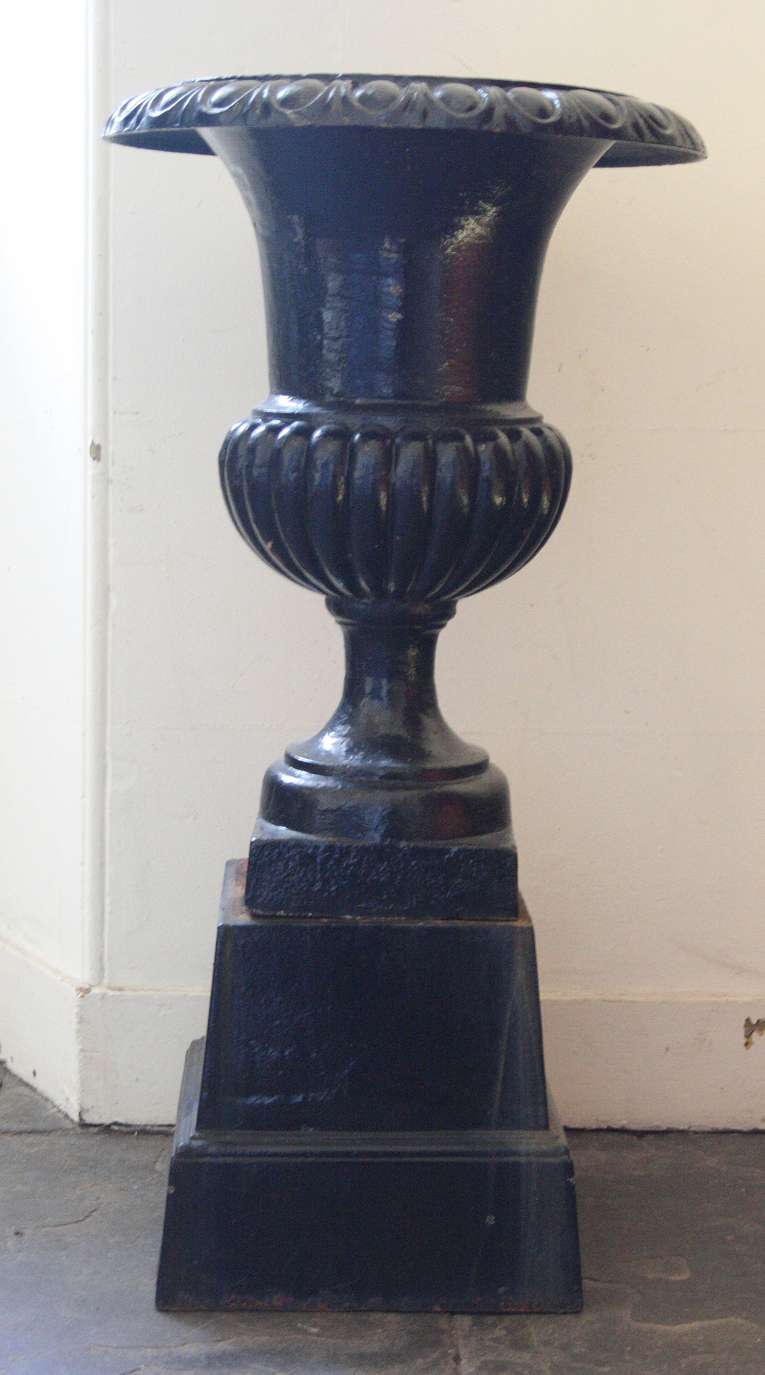 A pair of Victorian cast iron garden urns