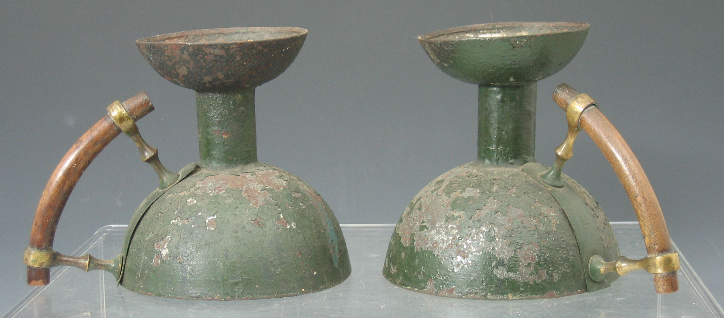 Christopher Dresser (1834-1904) A pair of Kardofan enamelled chamber candlesticks,