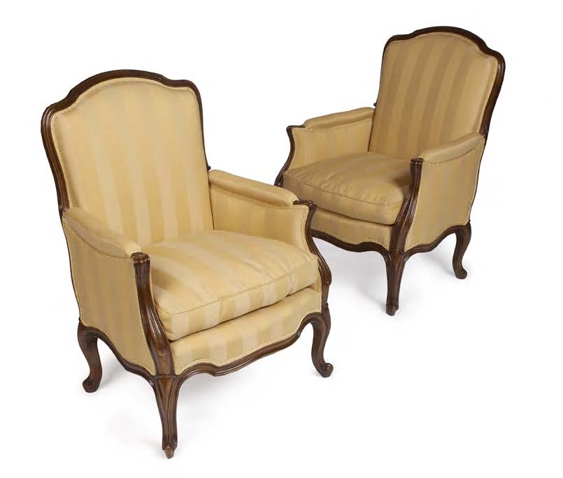A pair of beech-framed upholstered armchairs,