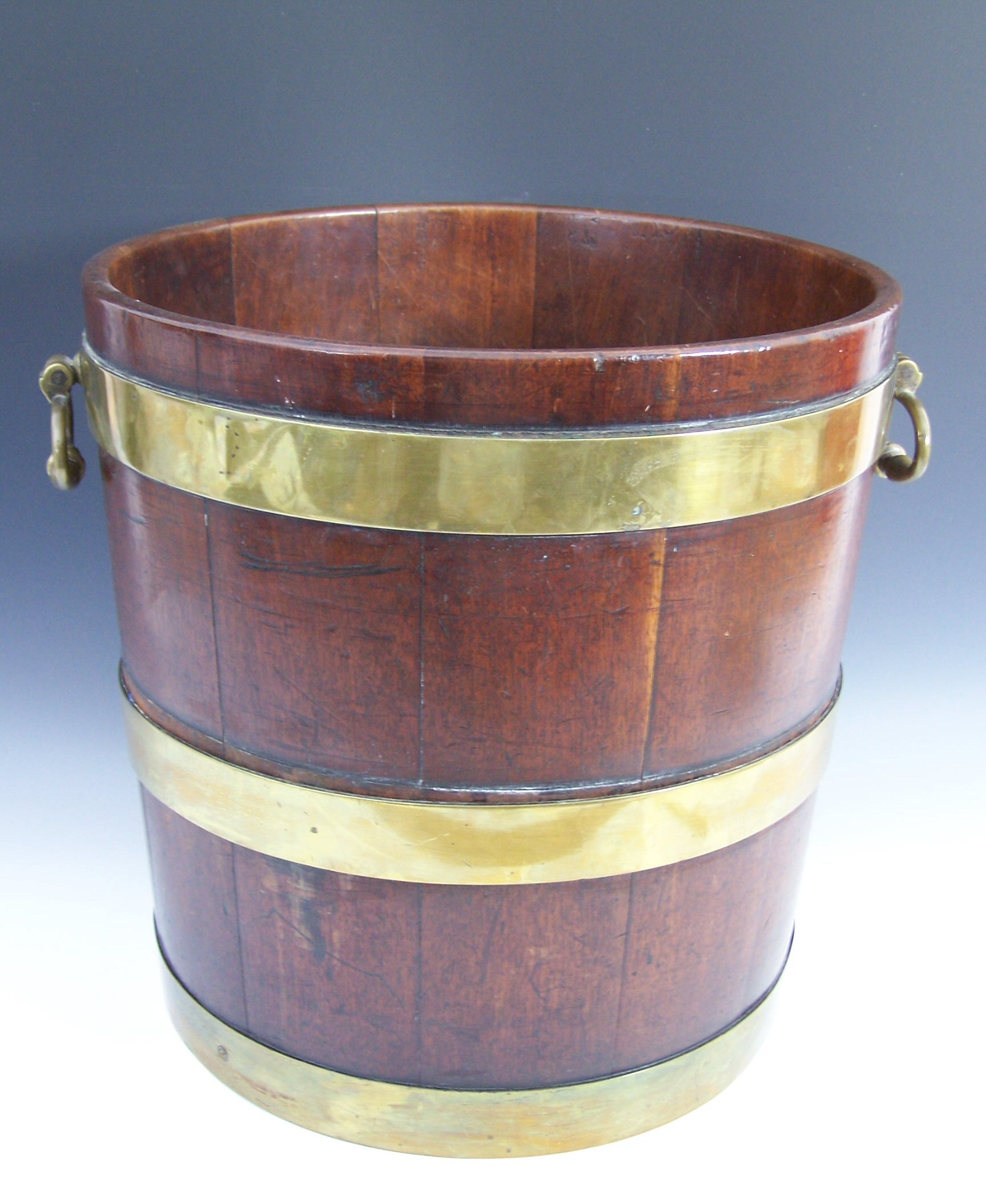 A George III mahogany and brass bound peat bucket,