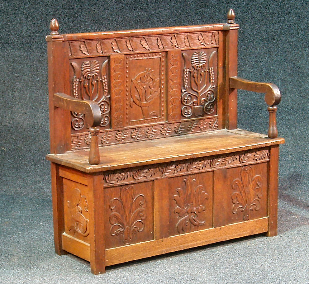 A late Victorian oak hall settle,