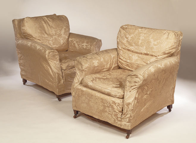A pair of upholstered easy armchairs