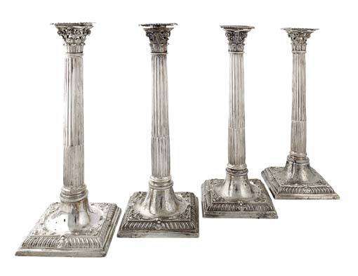 A matched set of four George III cast table candlesticks