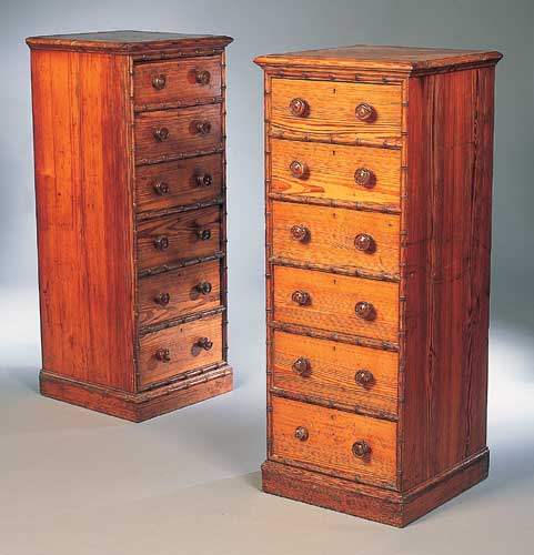 A pair of tall chest of drawers