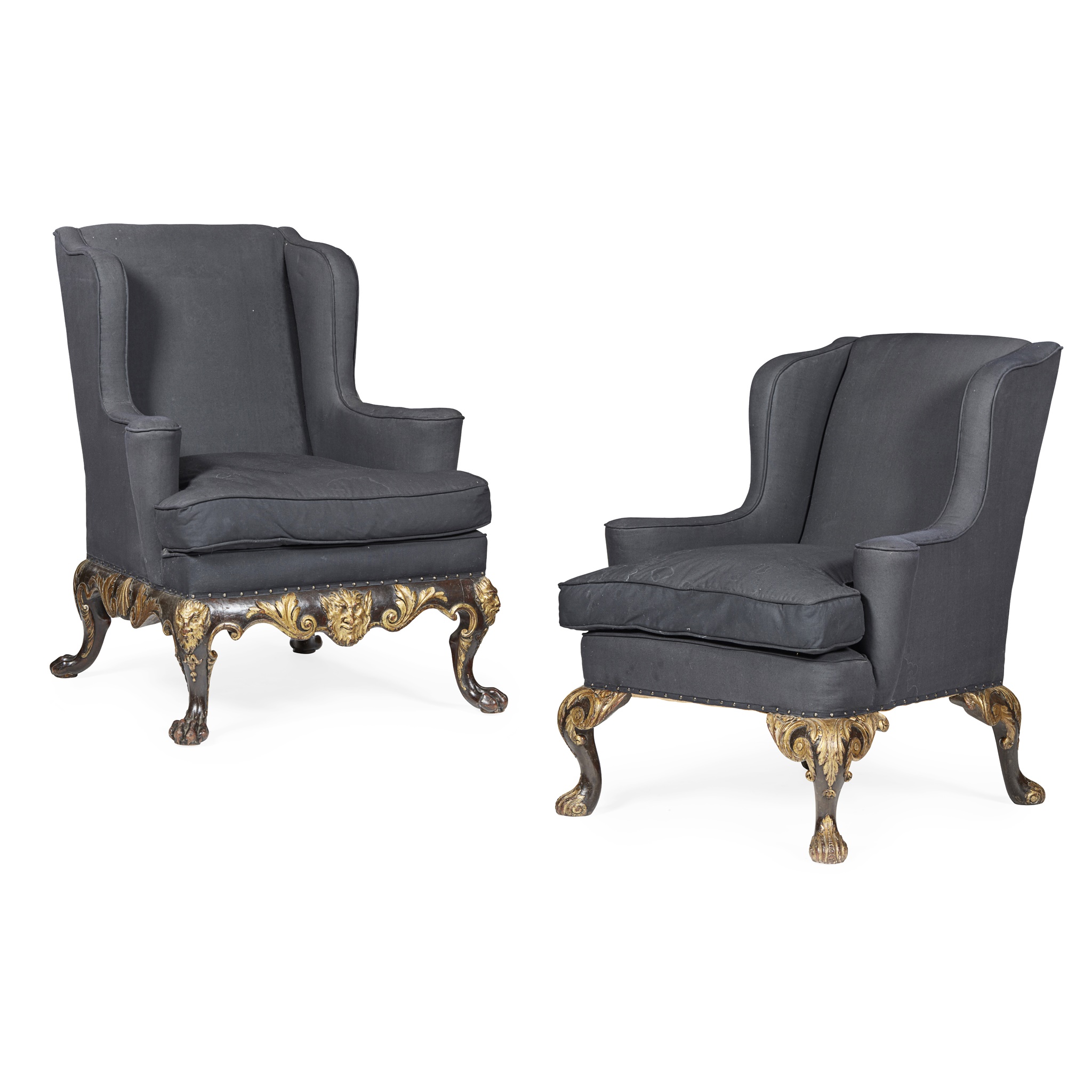 TWO GEORGE II STYLE EBONISED MAHOGANY AND PARCEL GILT WING ARMCHAIRS