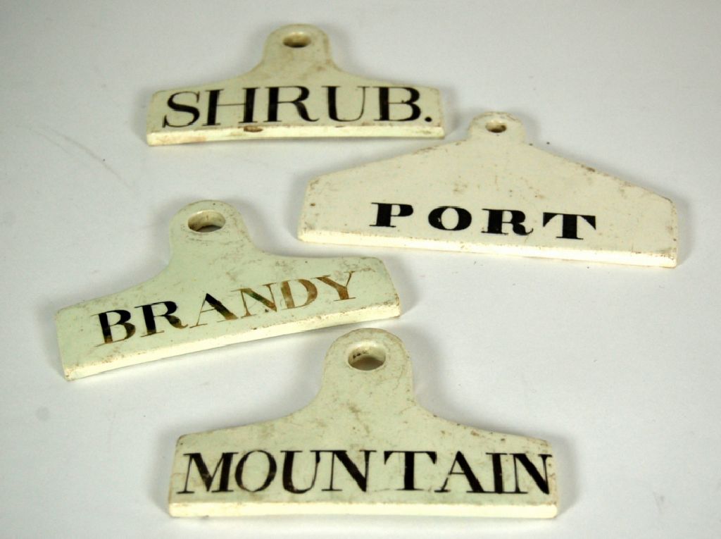 FOUR ENGLISH POTTERY SPIRIT LABELS