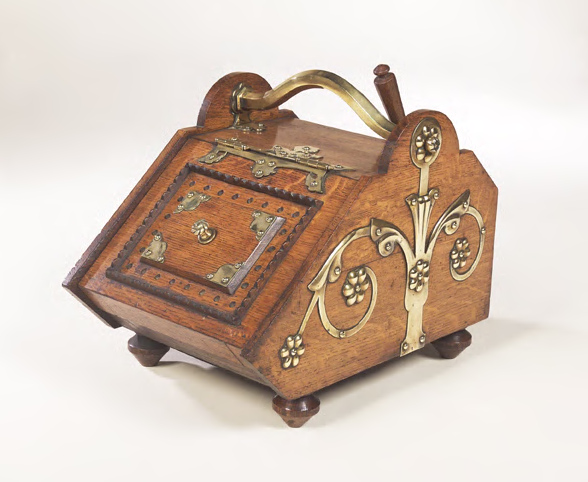 Attributed to Christopher Dresser A Benham and Froud oak and brass bound coal skuttle,