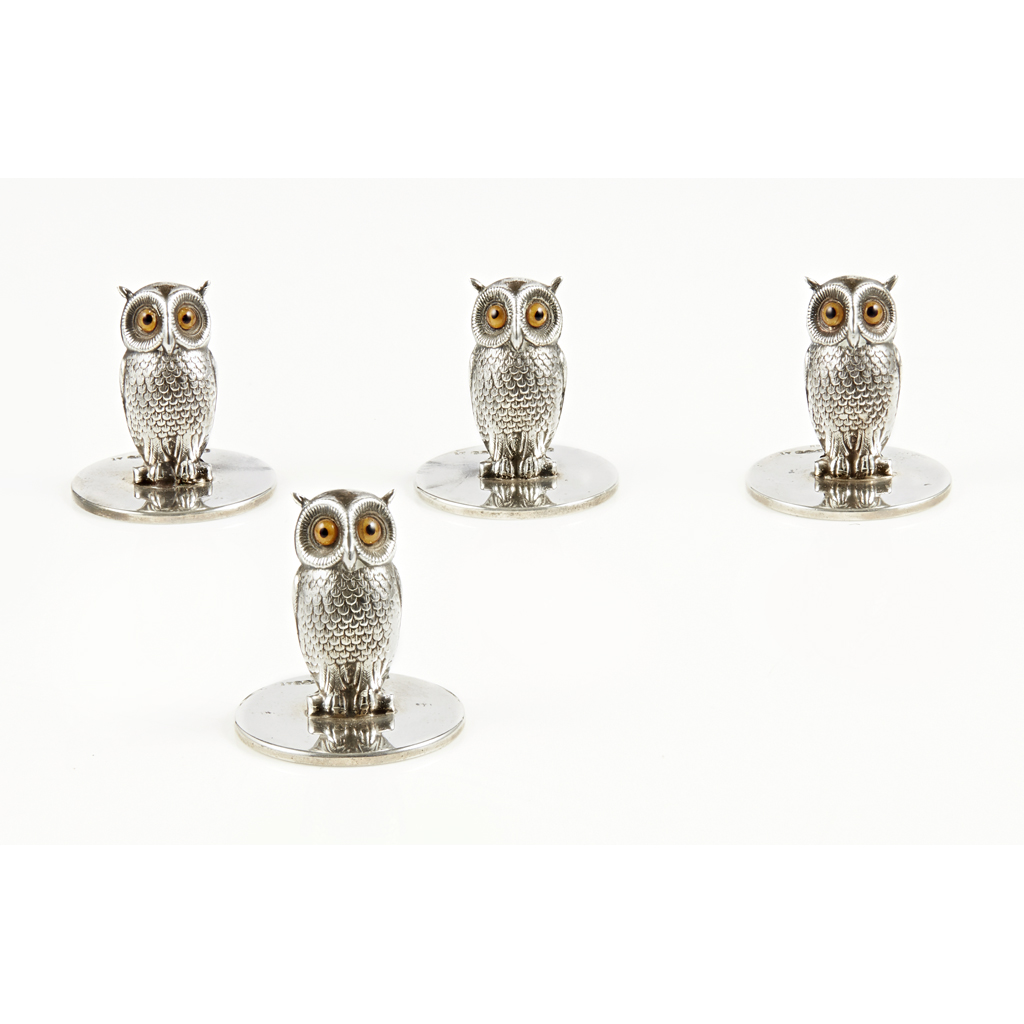 A set of four 'owl' place card holders