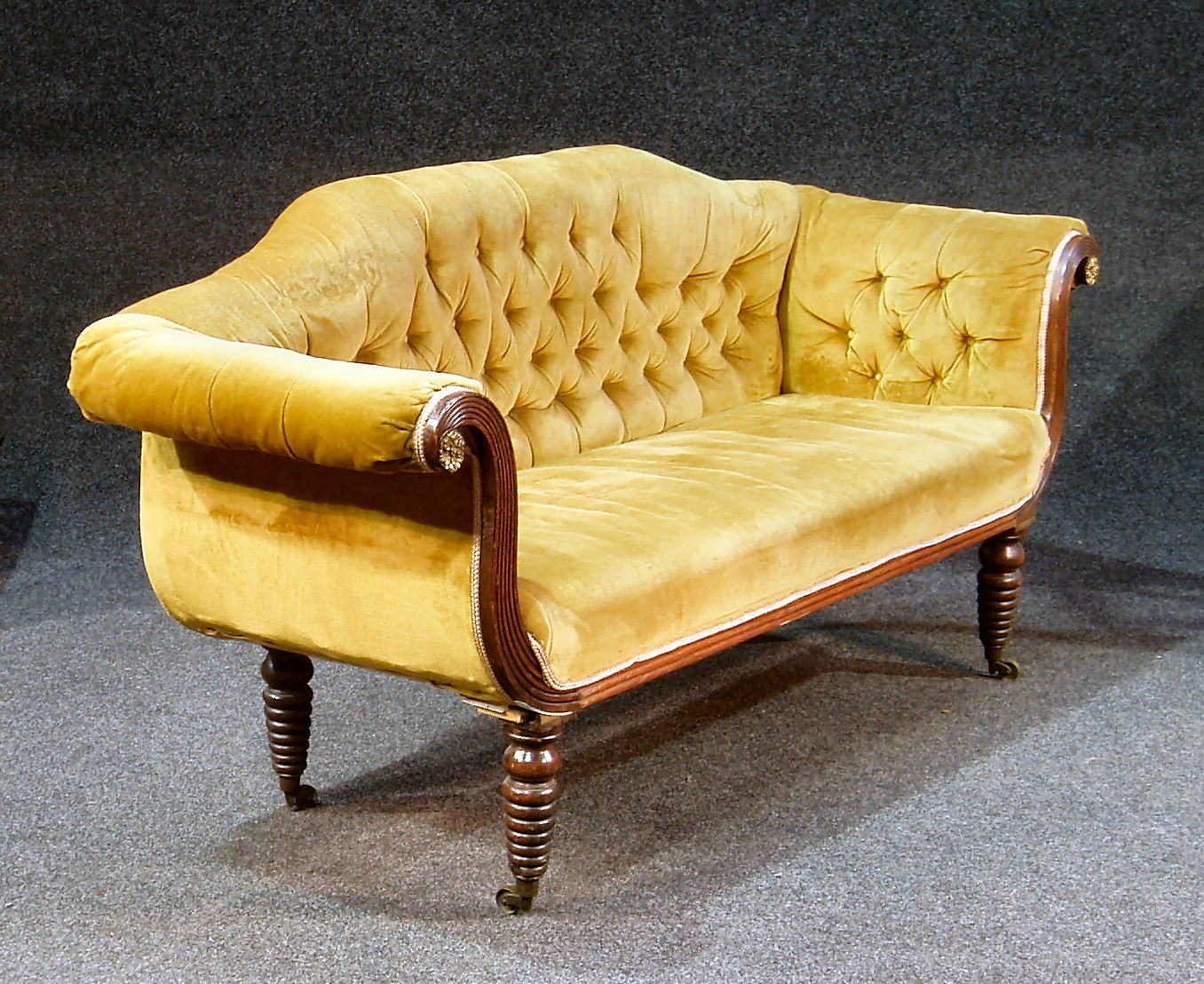 An early 19th century mahogany framed settee