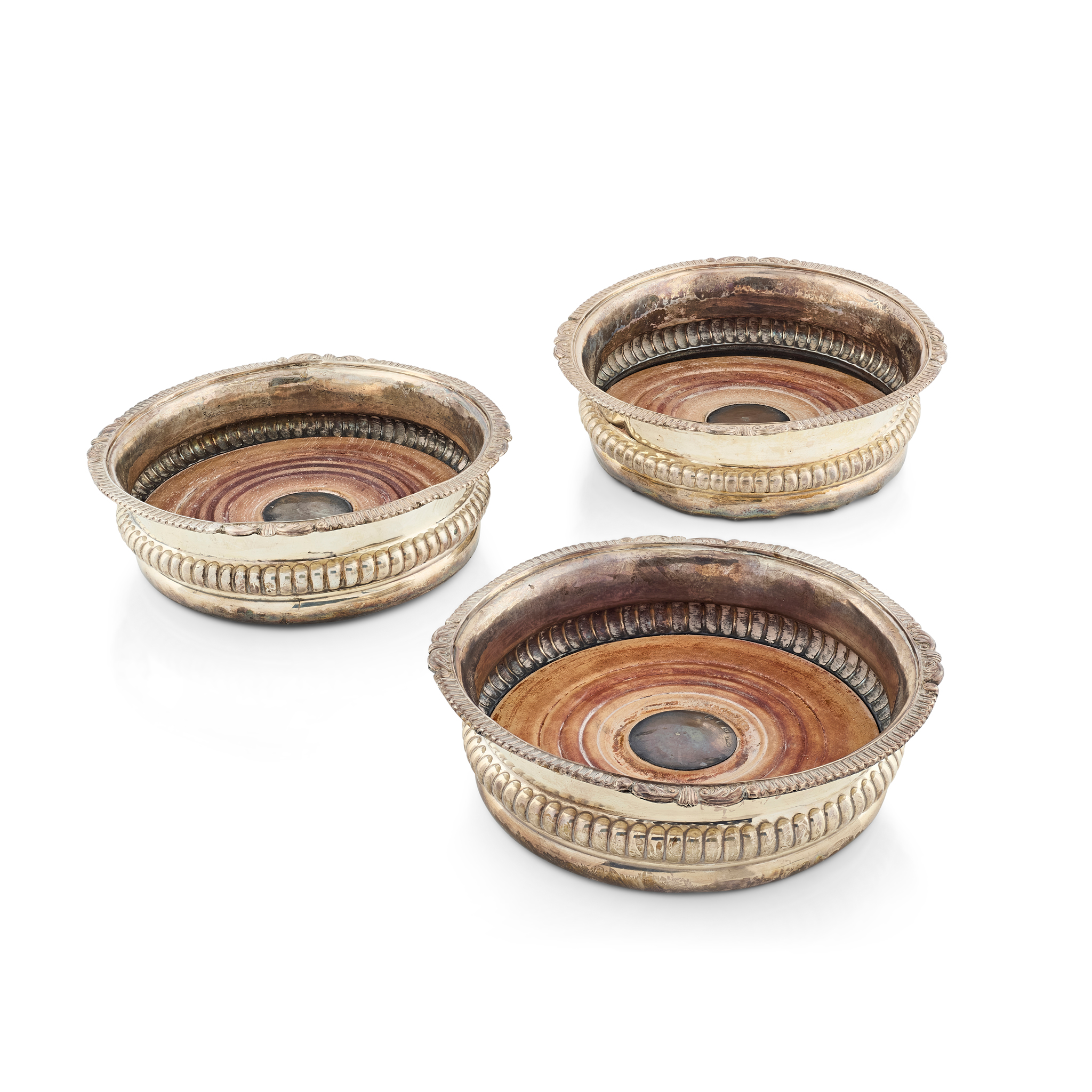 A SET OF THREE GEORGE III WINE COASTERS