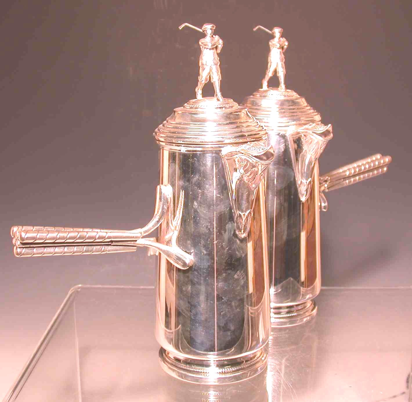 A pair of silver plated golfing coffee pots,