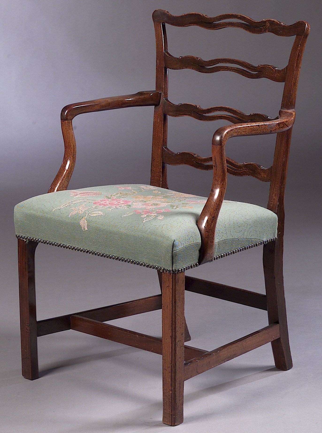 A mahogany ladderback carver