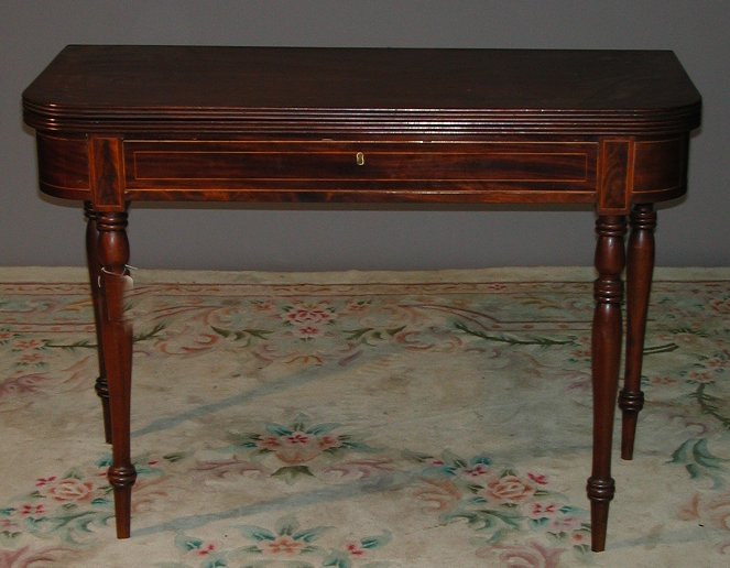 A Victorian mahogany and rosewood string fold over tea table