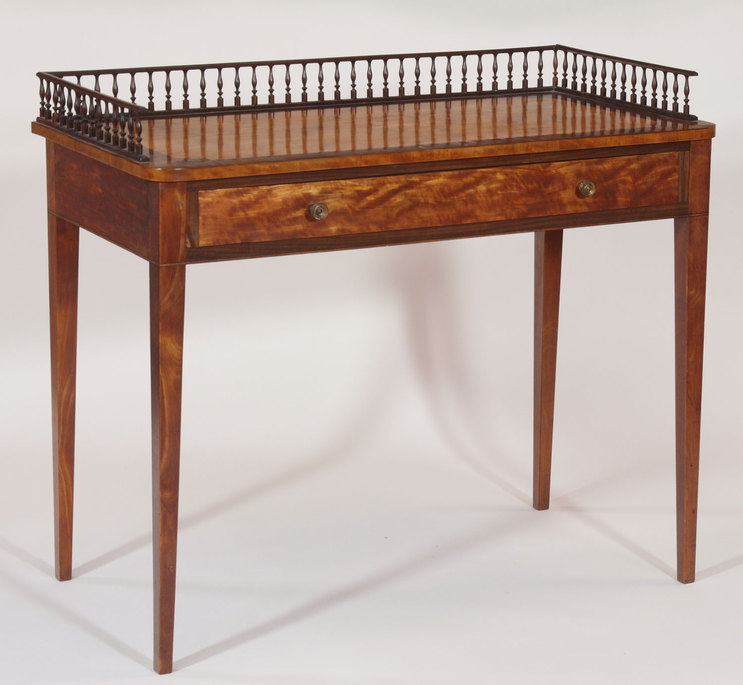 An early 19th century mahogany and satinwood side table
