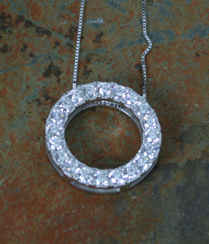 A diamond circular pendant,