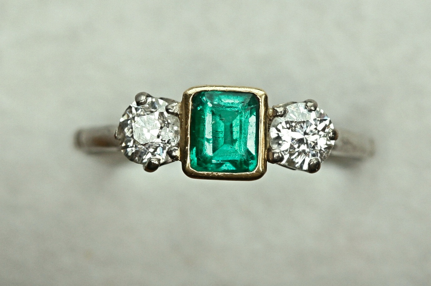 An emerald and diamond ring