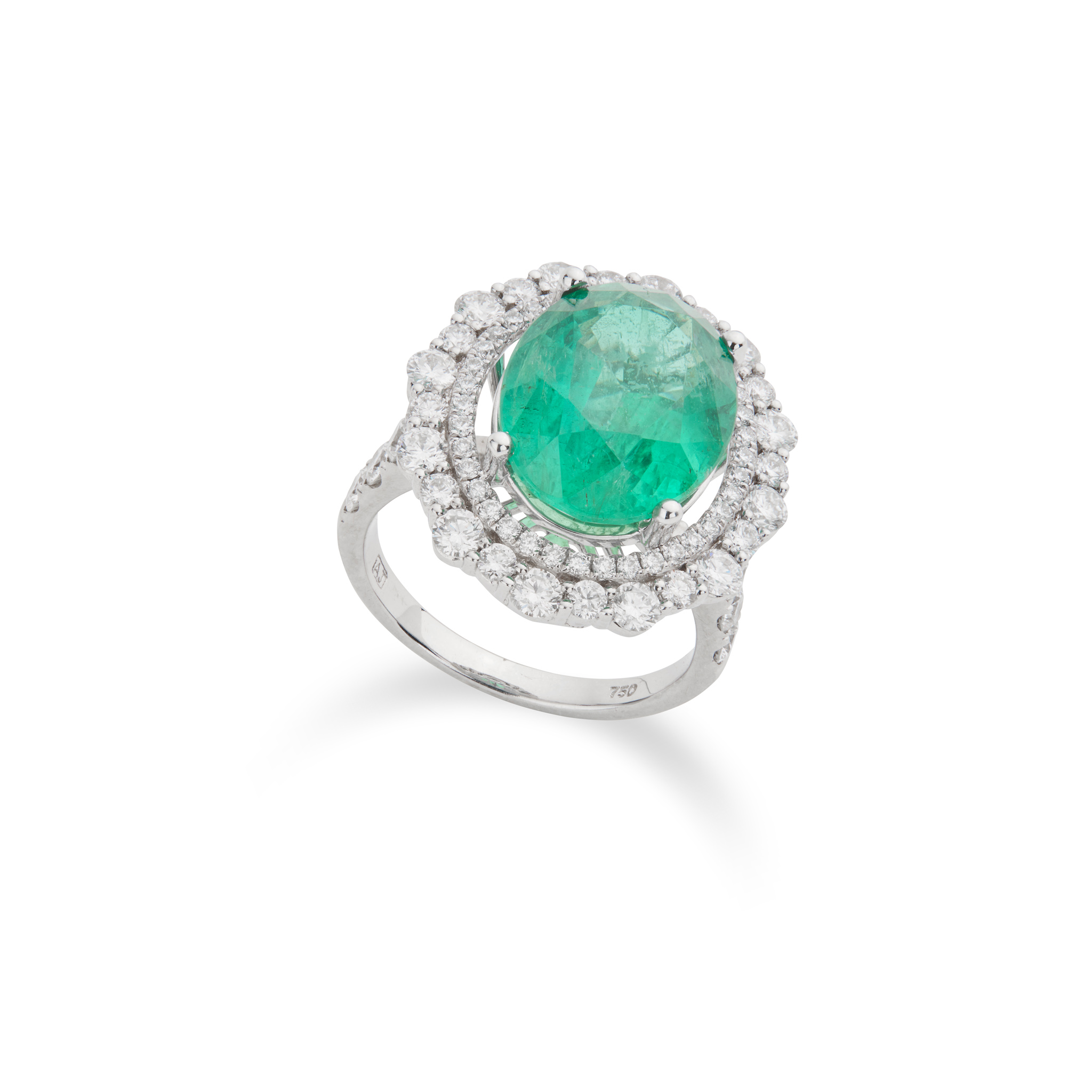 An emerald and diamond cluster ring