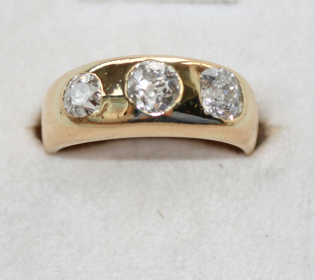A late Victorian 18ct gold mounted three-stone diamond ring,