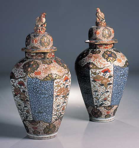 A large pair of Japanese Imari octagonal section baluster vases and covers