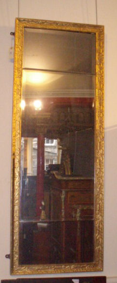 An early 18th century giltwood framed landscape mirror