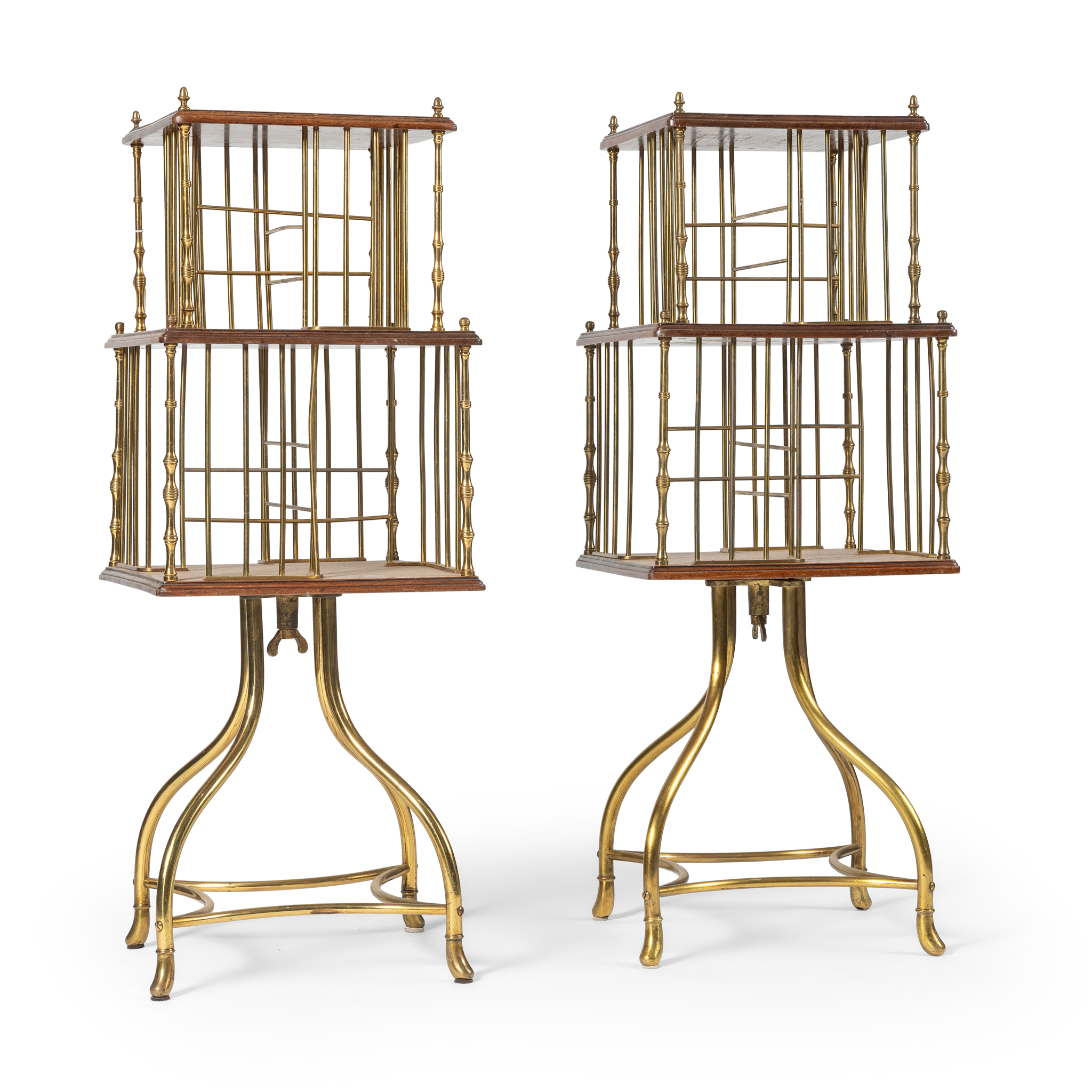 A PAIR OF MAHOGANY AND BRASS REVOLVING BOOKCASES