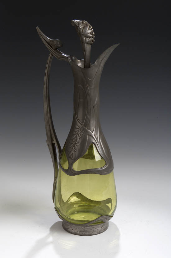 An Art Nouveau pewter mounted claret jug and stopper