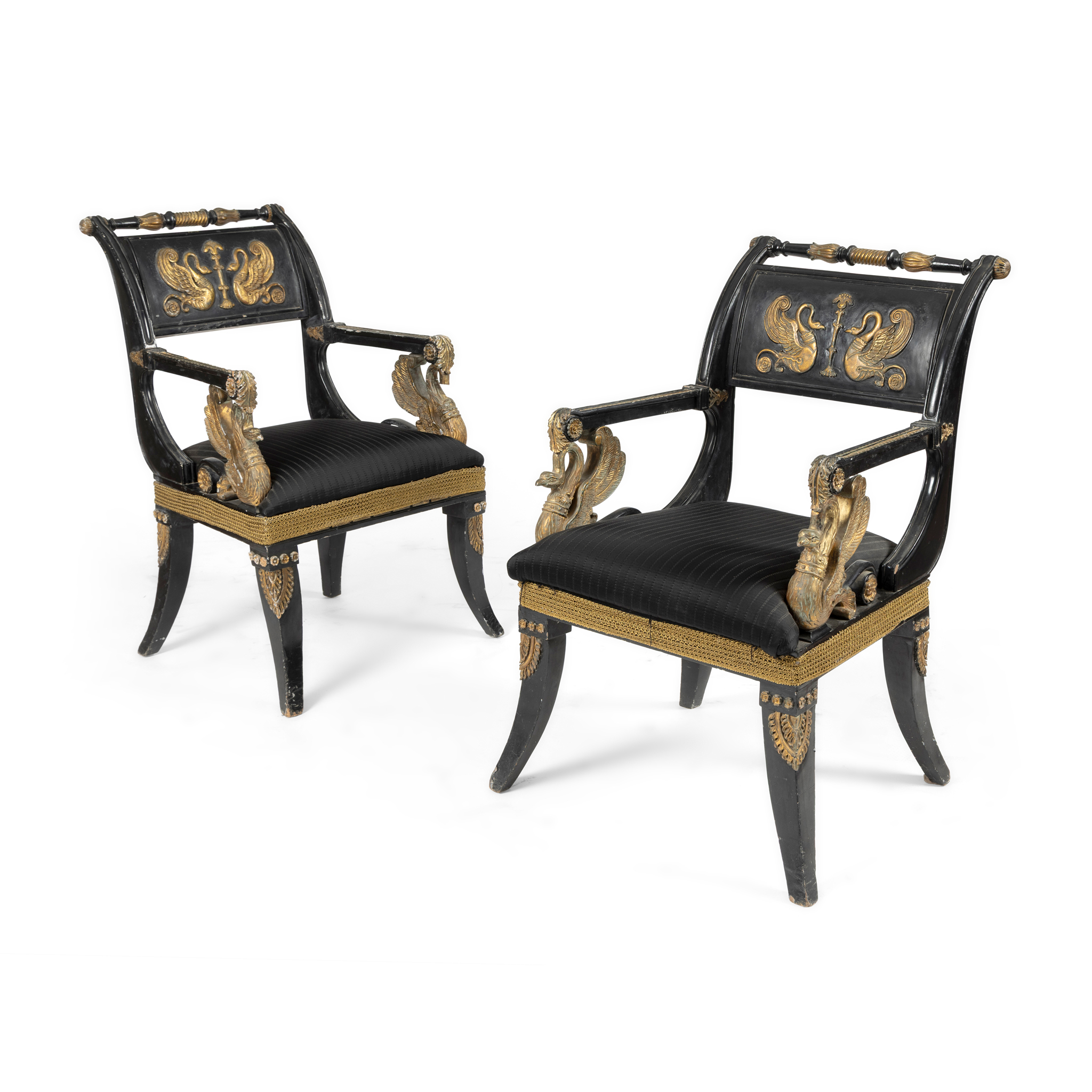 A MATCHED PAIR OF EBONISED AND GILT DECORATED ARMCHAIRS