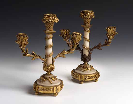 A pair of gilt bronze and marble three branch table candelabra
