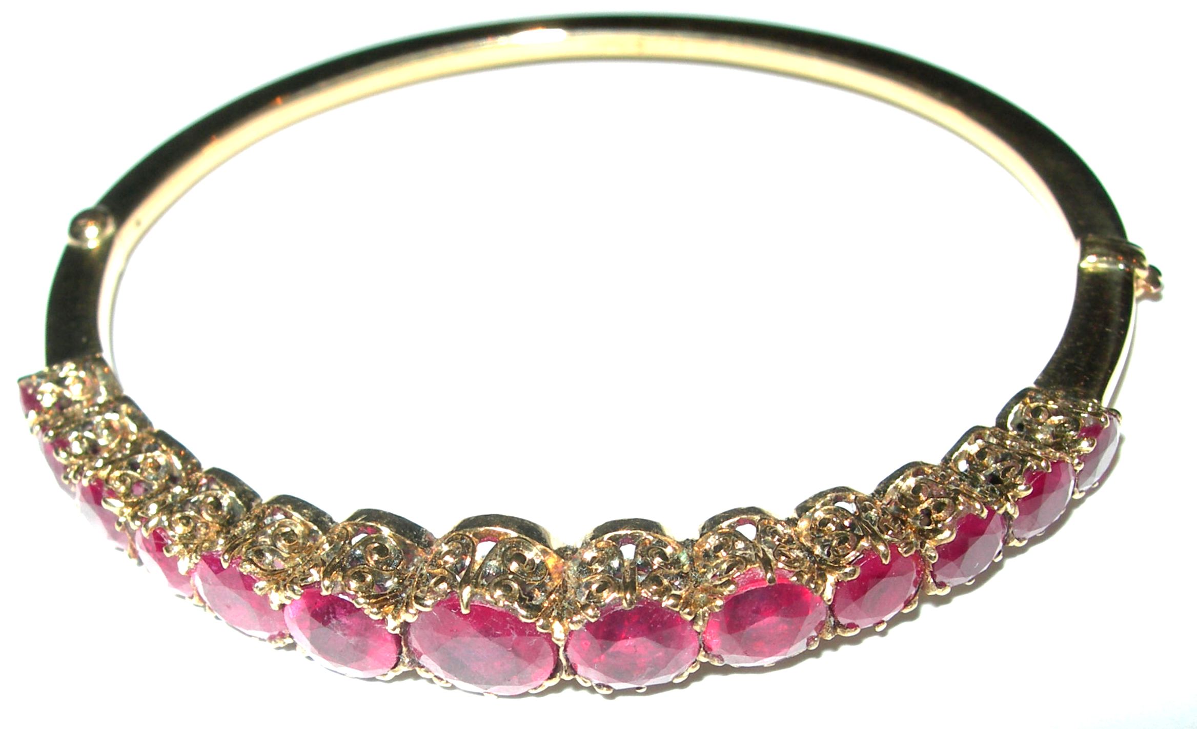 An Edwardian 18ct gold mounted ruby bangle,