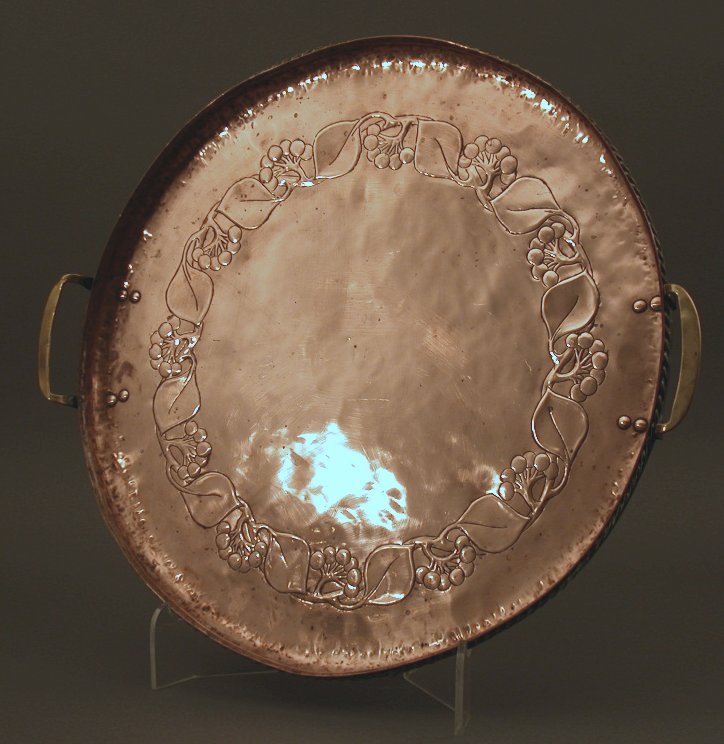 An Arts and Crafts circular copper tray
