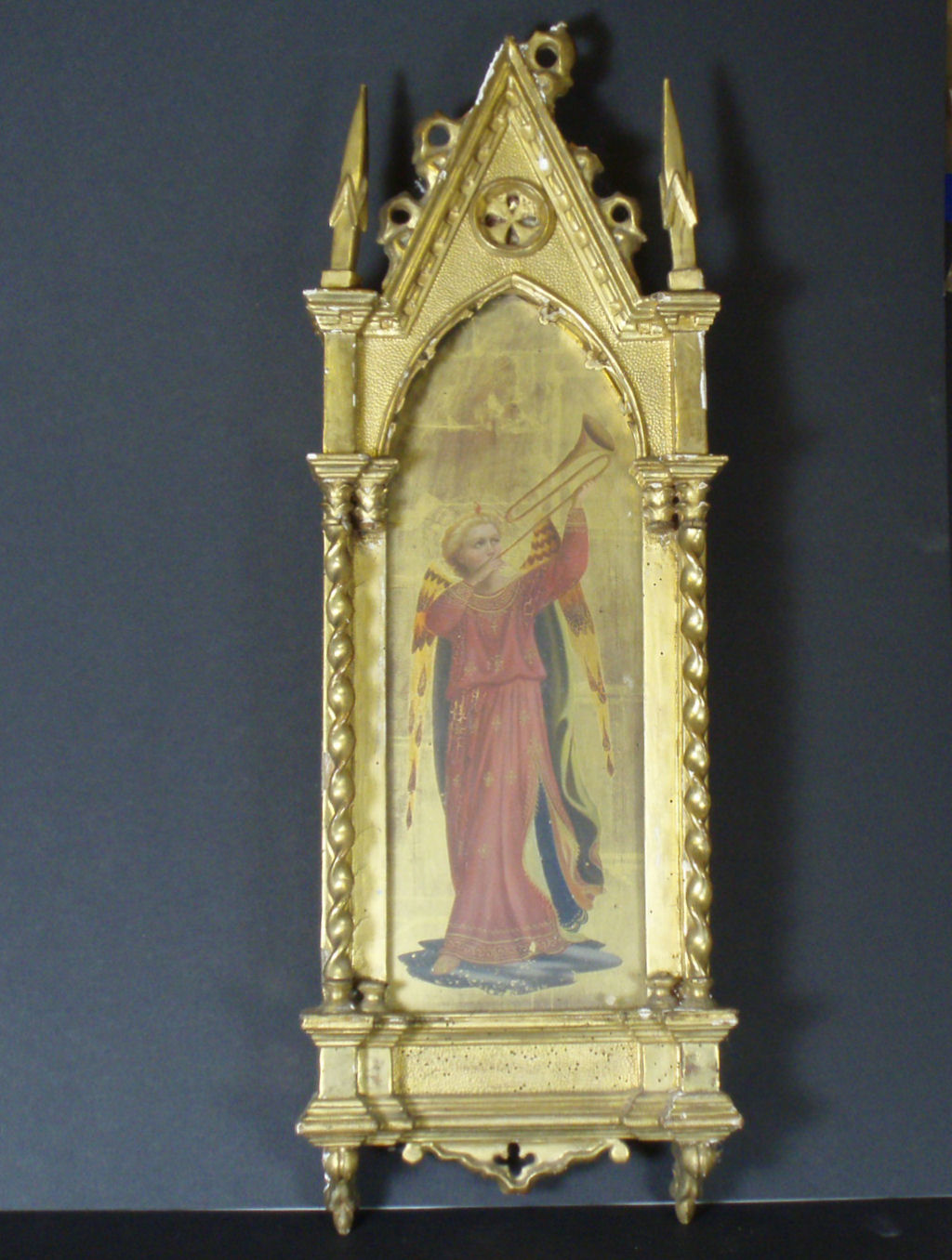 A 19th century Renaissance Revival painted panel of a trumpeting angel