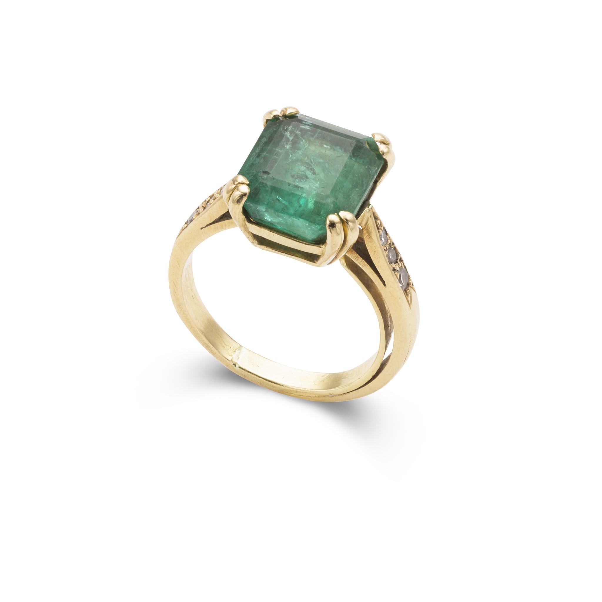 An emerald and diamond ring on plain band