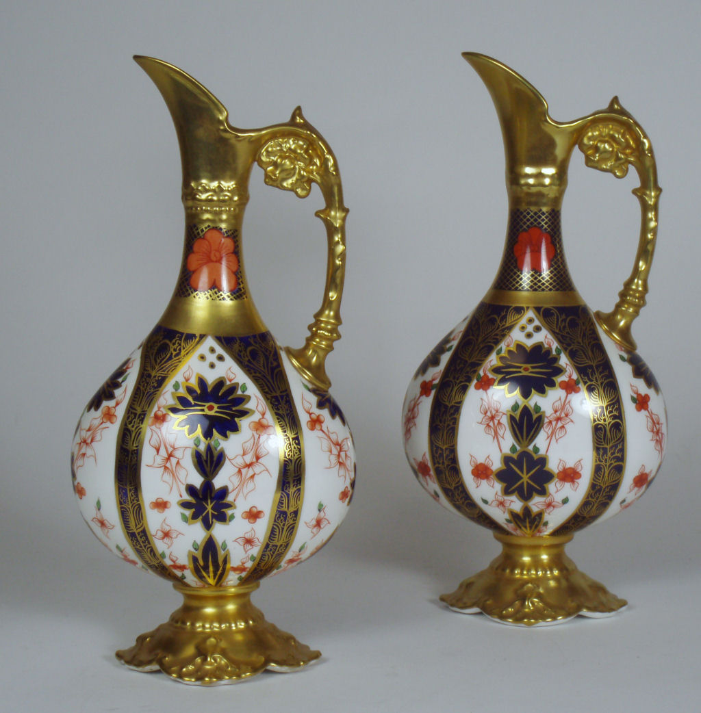 A pair of Royal Crown Derby ewers