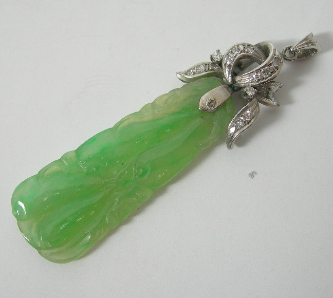 A jade and diamond pendant,