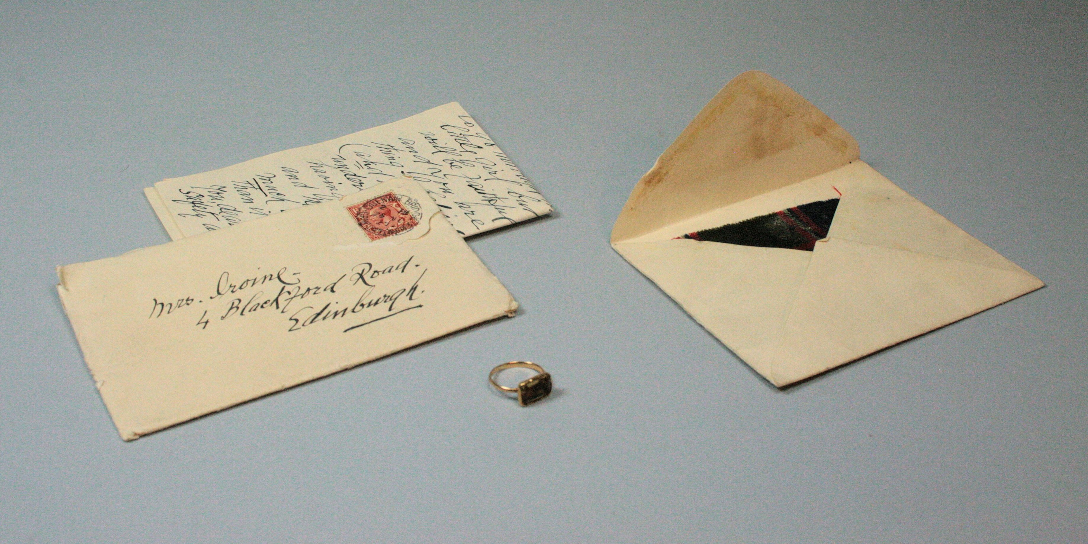 A Jacobite ring and fragment of Prince Charles Edward Stewart tartan