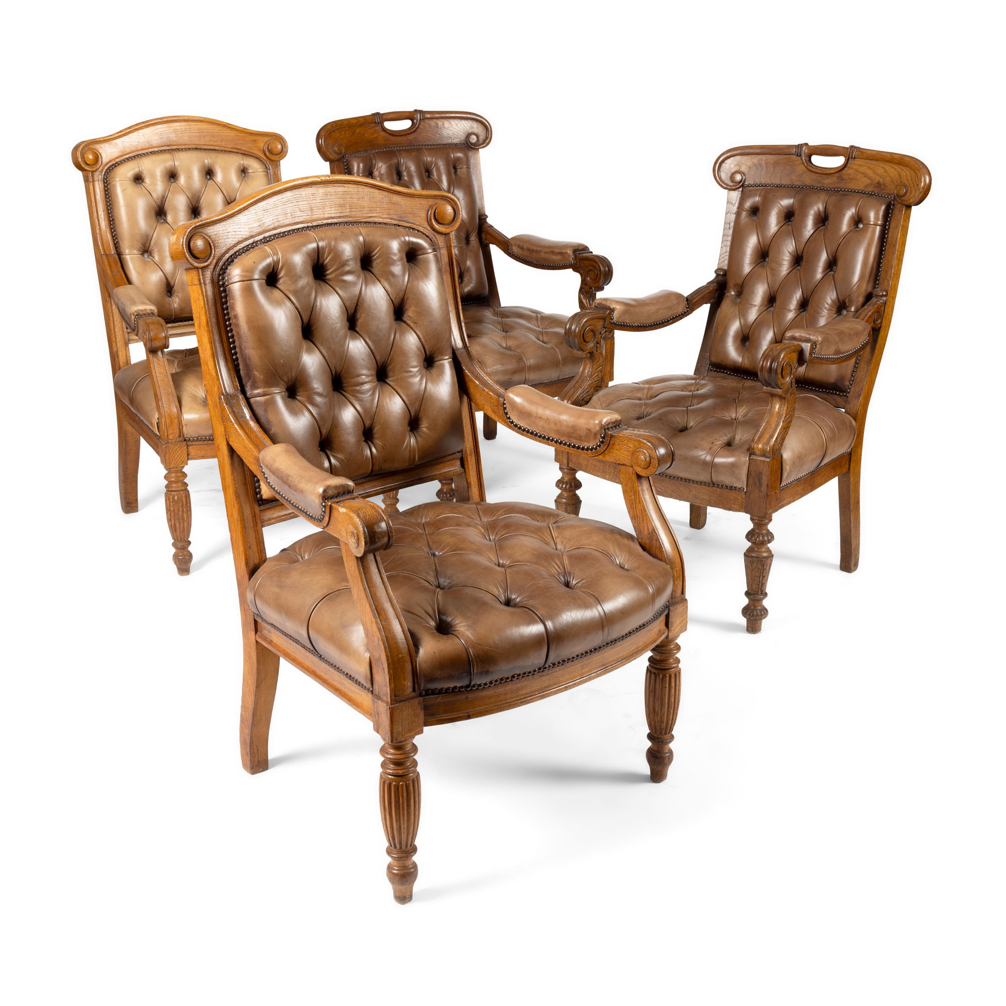 A PAIR OF LATE VICTORIAN OAK AND LEATHER UPHOLSTERED LIBRARY ARMCHAIRS