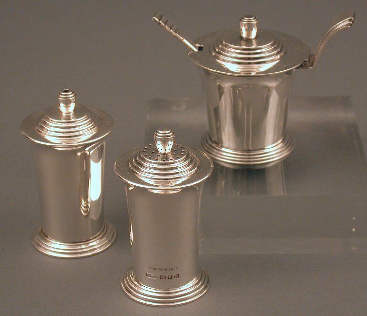 An Art Deco three piece silver cruet