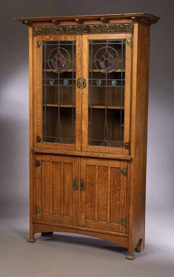 An Arts and Crafts oak bookcase cabinet