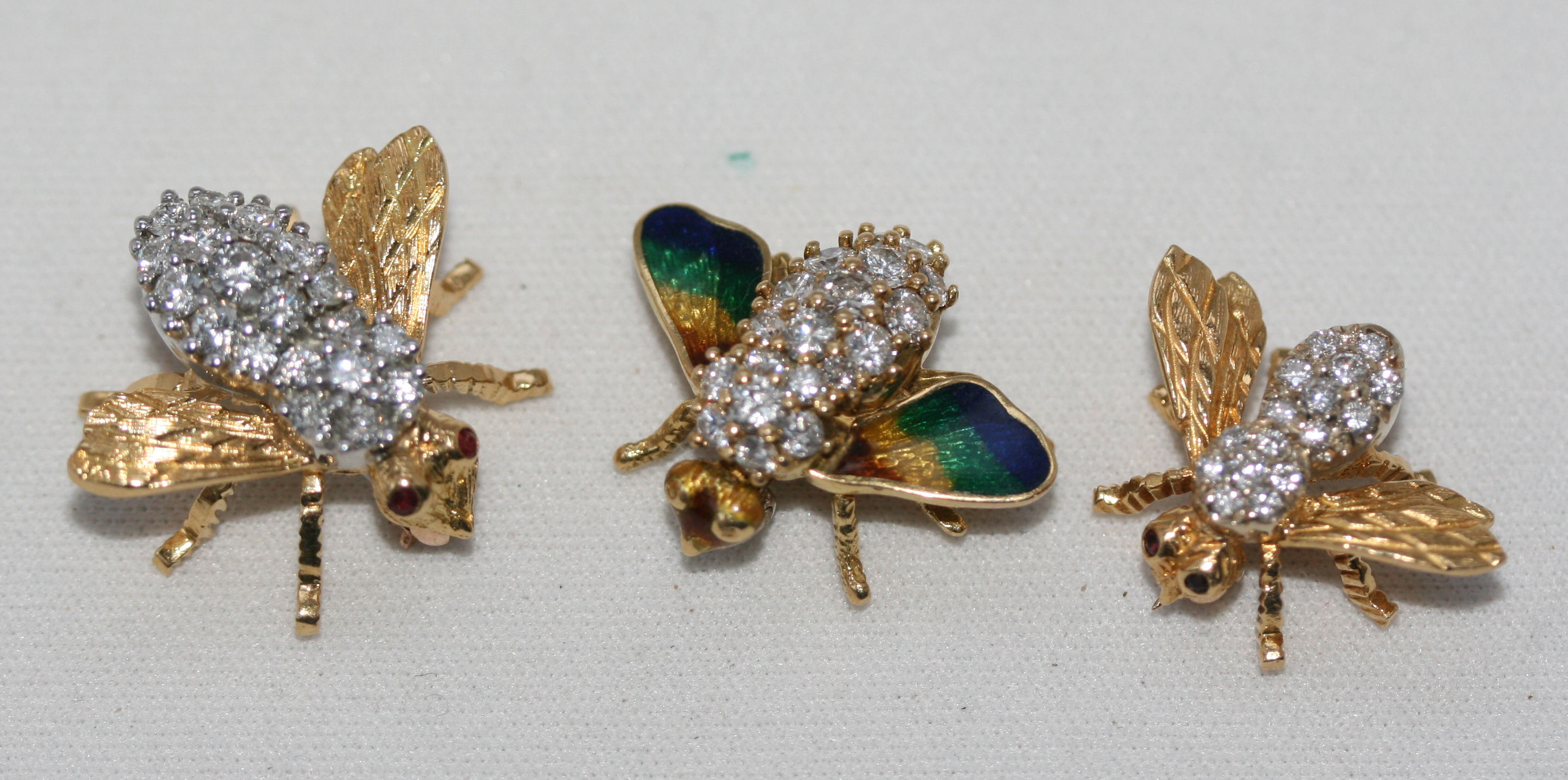A group of three diamond set bee form brooches