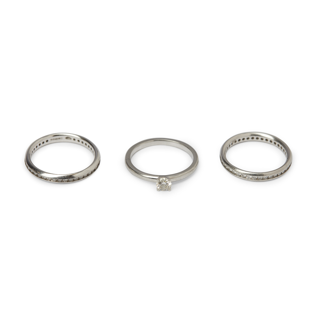 Three platinum and diamond set rings