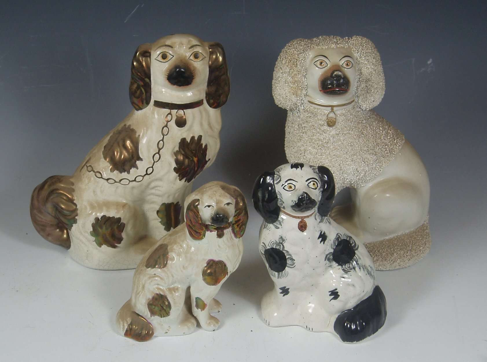 A collection of Staffordshire pottery dogs,