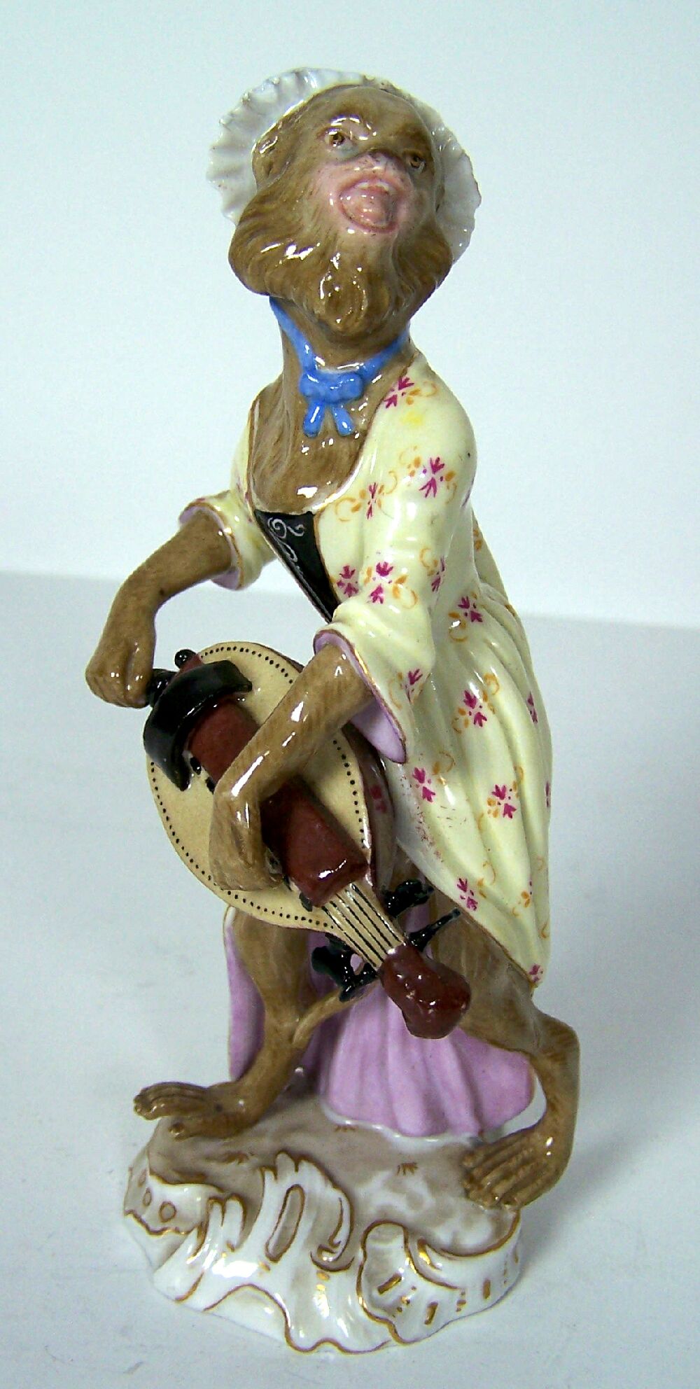 A 19th century Meissen figure of Monkey playing mandolin after a model by Peter Reinicke