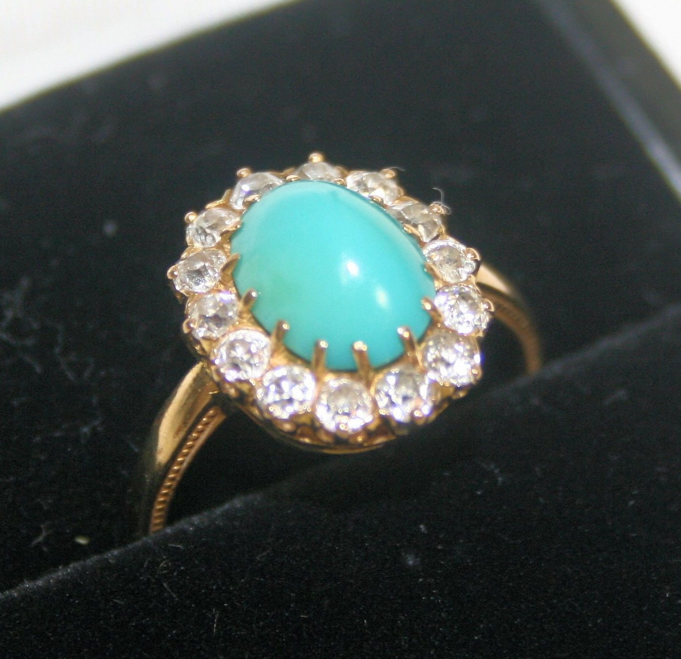 A turquoise and diamond set ring