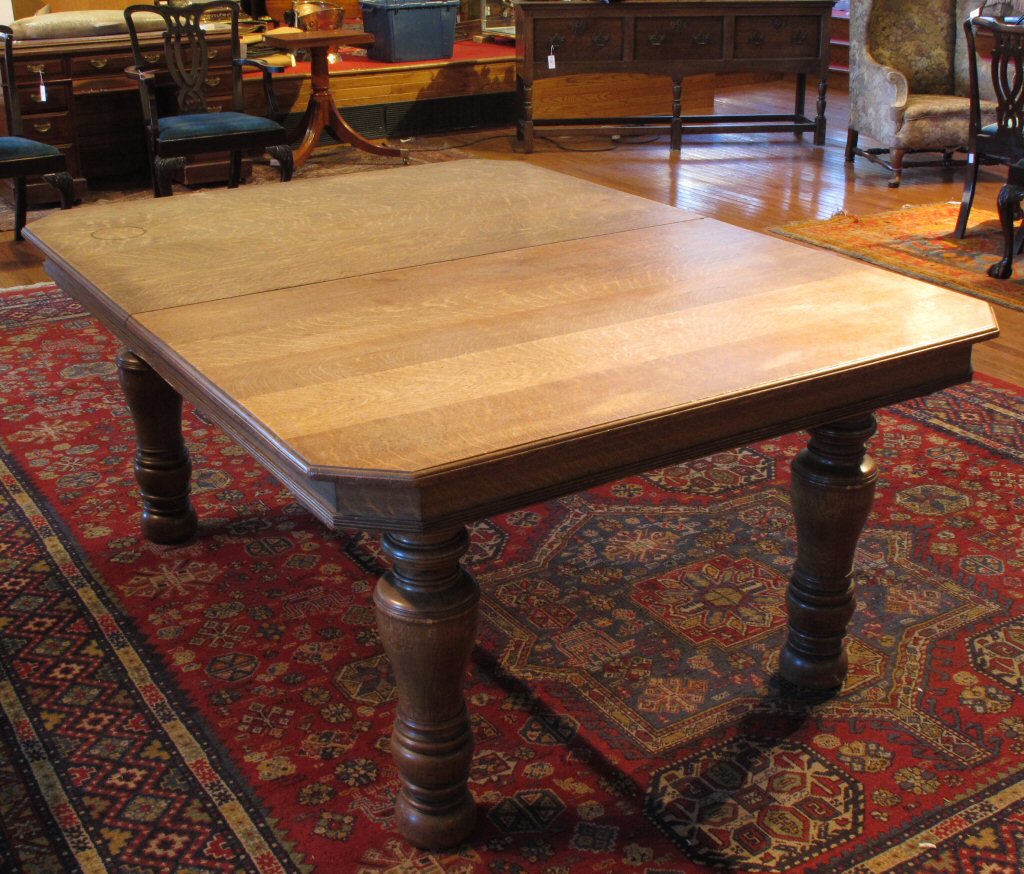 A large Victorian oak extending dining table