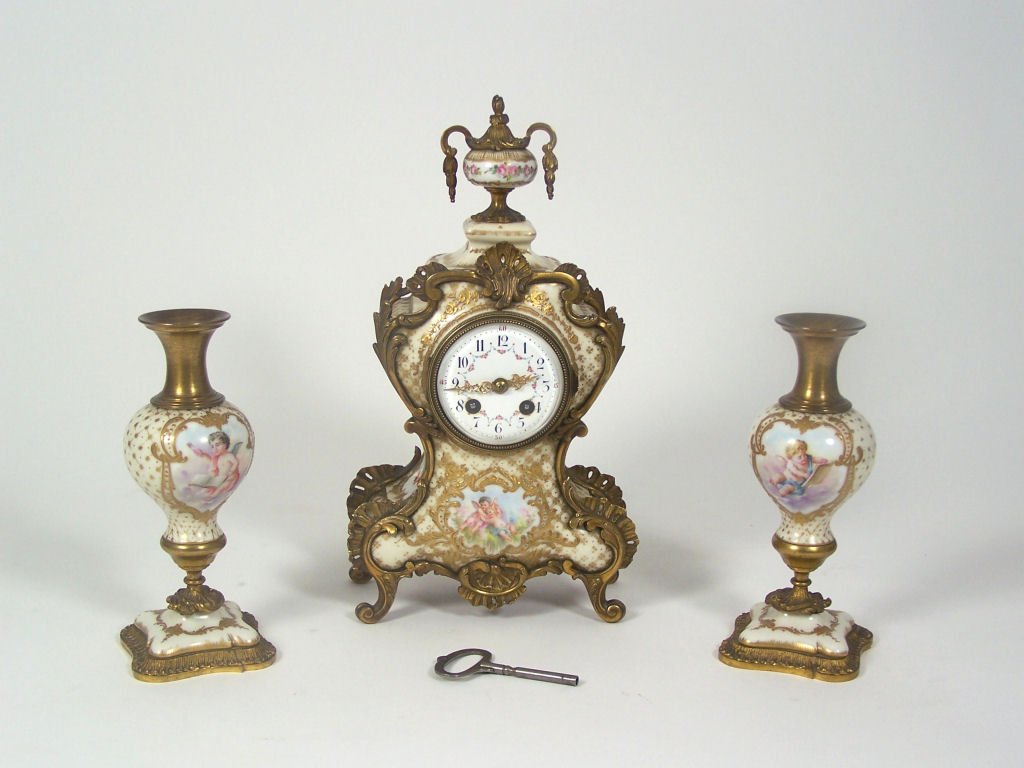 A 19th century porcelain and gilt bronze mounted clock garniture In the Louis XV style