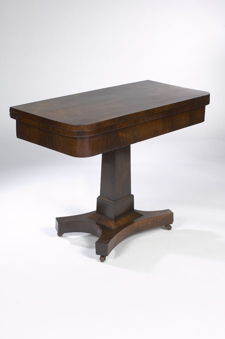An early 19th century rosewood foldover games table
